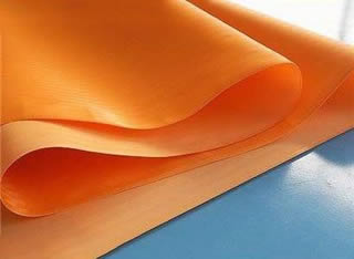 A piece of orange desulfurization mesh fabric with a smooth surface that ensure ease of peeling off filtered cake.
