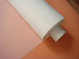 A roll of white polyester filter mesh for industrial filtration and screen printing.