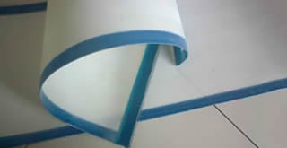 Two pieces of polyester sludge dewatering belts with blue edges have smooth surface and uniform apertures.